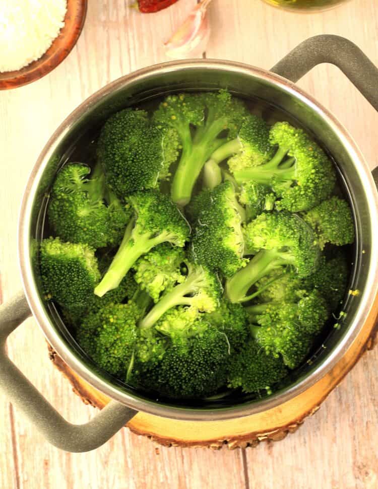 Broccoli florets boiled in sauce pan for frascatula recipe.