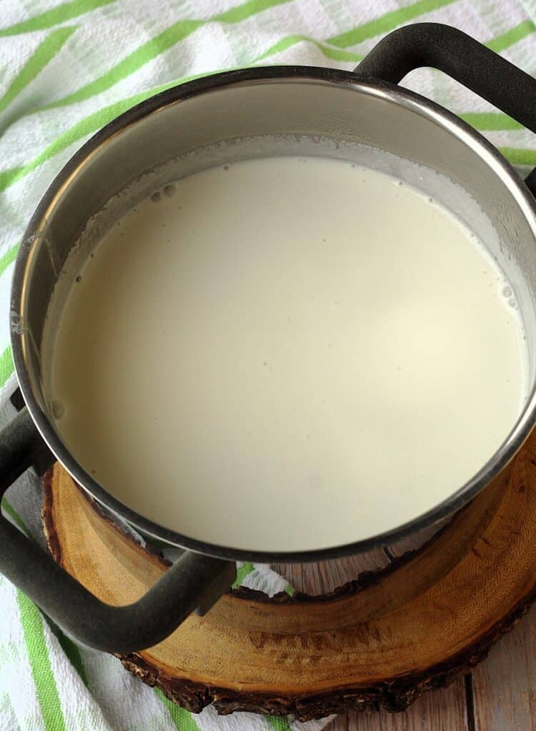 Curdled almond milk in sauce pan.