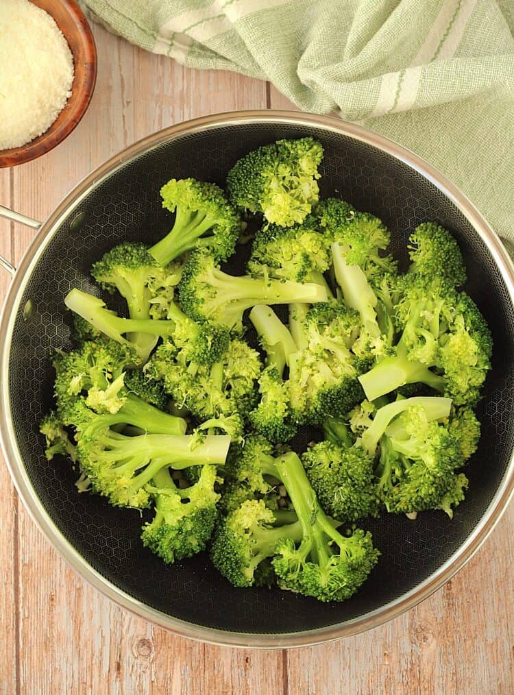 Broccoli sautéed in skillet with garlic.