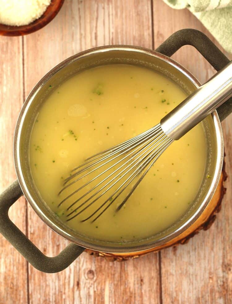 Durum wheat semolina polenta in sauce pan with whisk.