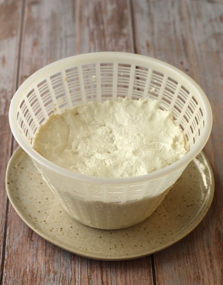Dairy free ricotta in ricotta mold on plate.