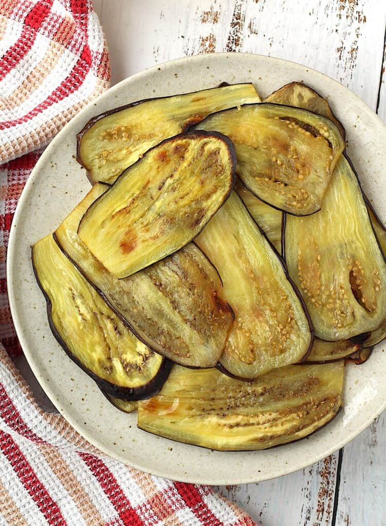 Oven roasted eggplant slices on plate.