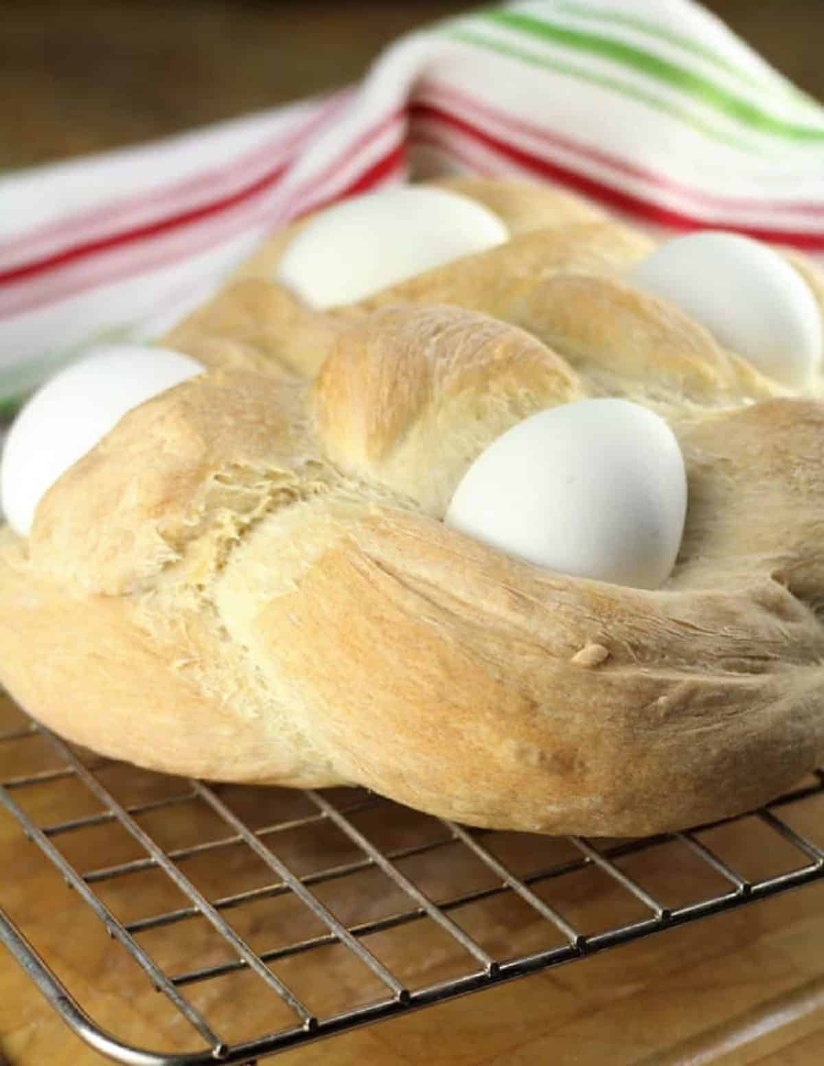 Sicilian braided Easter eggs with eggs in it on cooling rack.