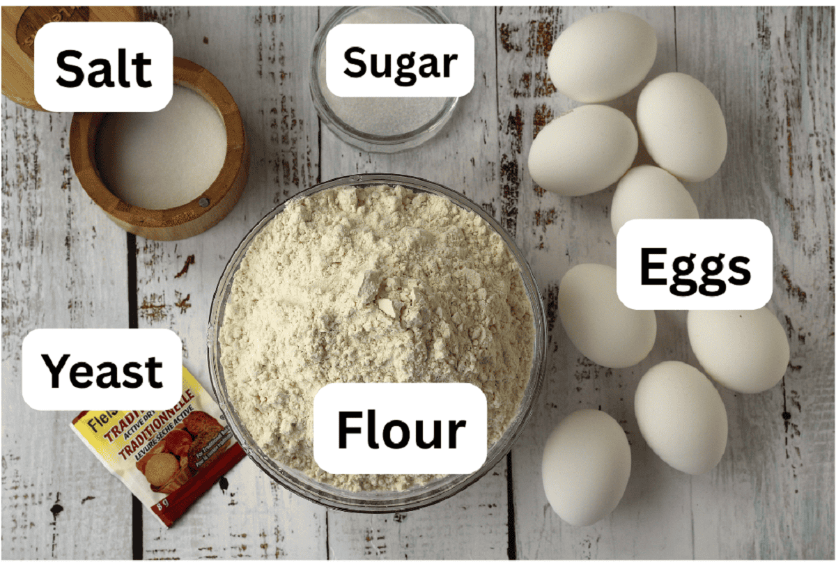 Bowls with flour, sugar, salt, eggs and yeast for making cuddura Easter bread.