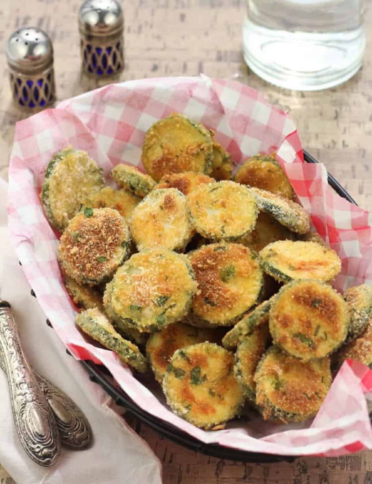 Baked Parmesan Zucchini Crisps Baked parmesan zucchini crisps piled in serving basket.