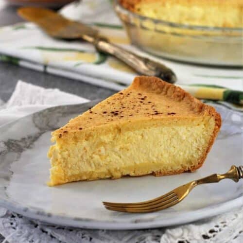 Slice of Sicilian ricotta pie on plate with fork on side.