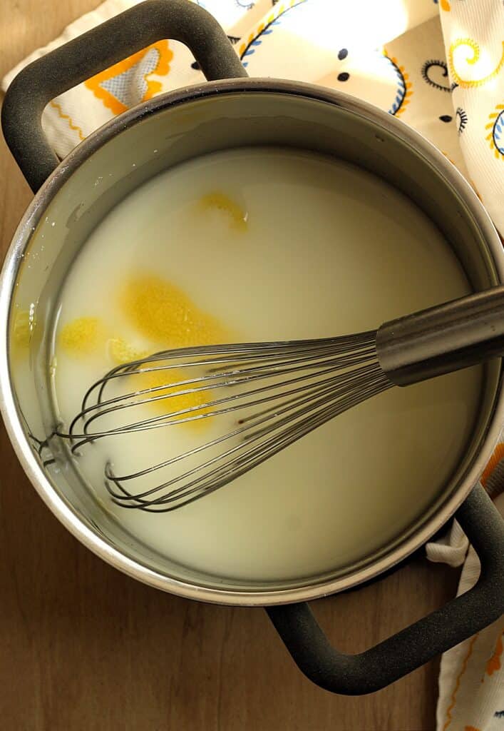 Lemon juice, water, sugar and cornstarch whisked in sauce pan for gelo di limone.