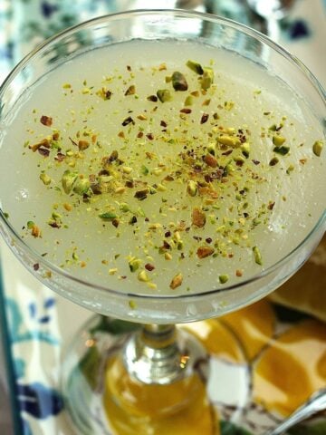 Sicilian gelo di limone, lemon pudding, topped with pistachios in glass.