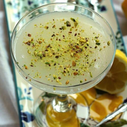 Sicilian gelo di limone, lemon pudding, topped with pistachios in glass.