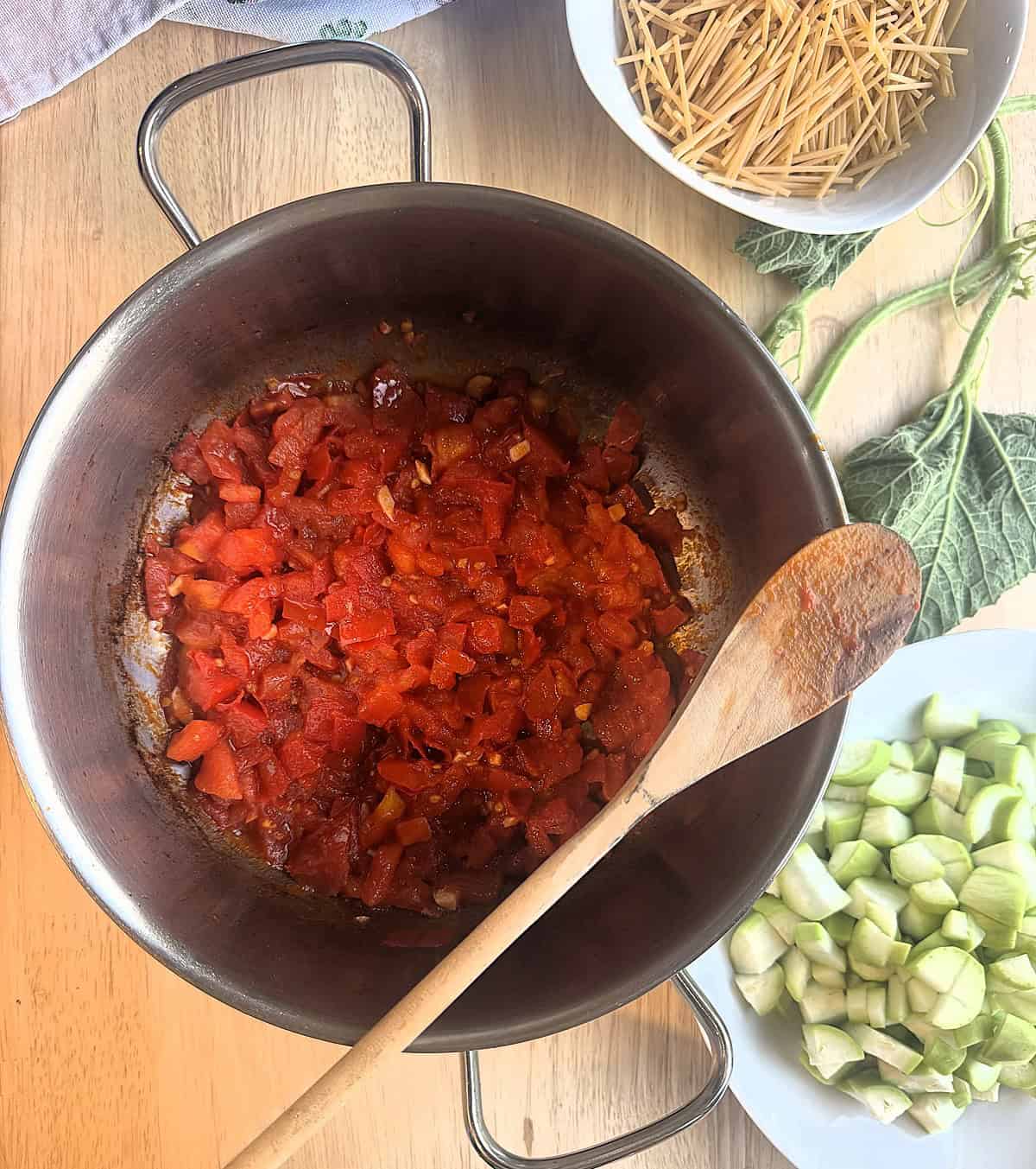 Diced tomatoes simmering in sauce pan.