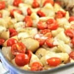 Patate vastase casserole dish with tomatoes and mozzarella in casserole dish.