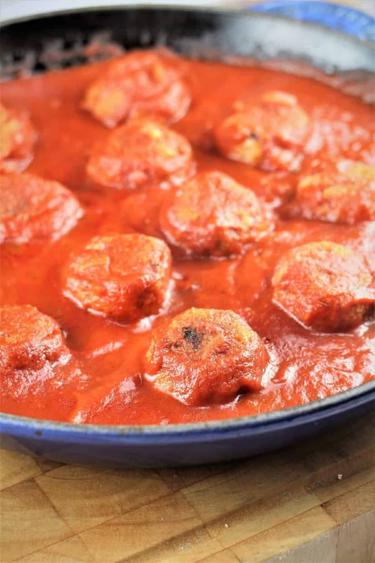 Eggplant meatballs simmered in tomato sauce. 