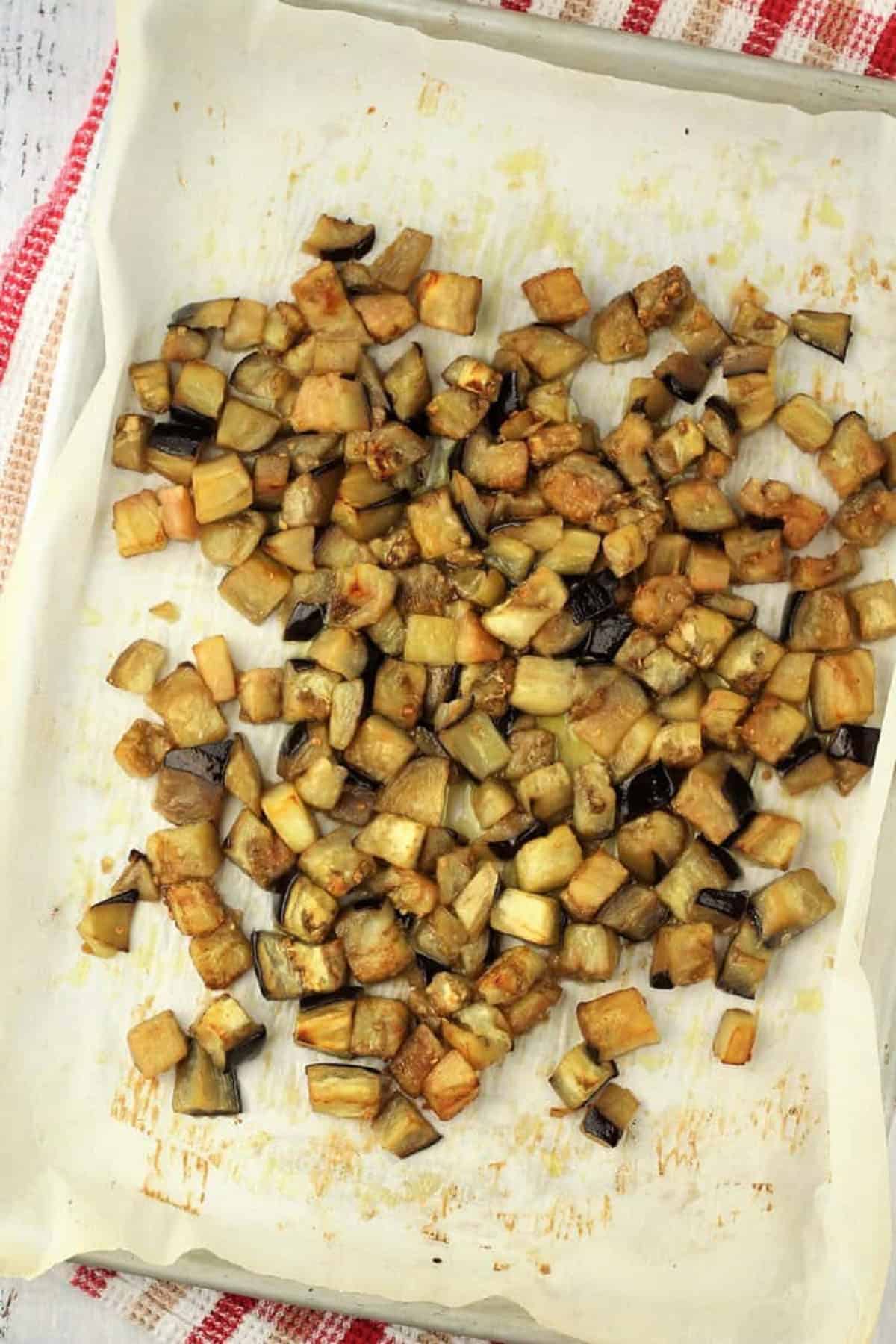 Roasted eggplant on baking sheet for eggplant meatballs.