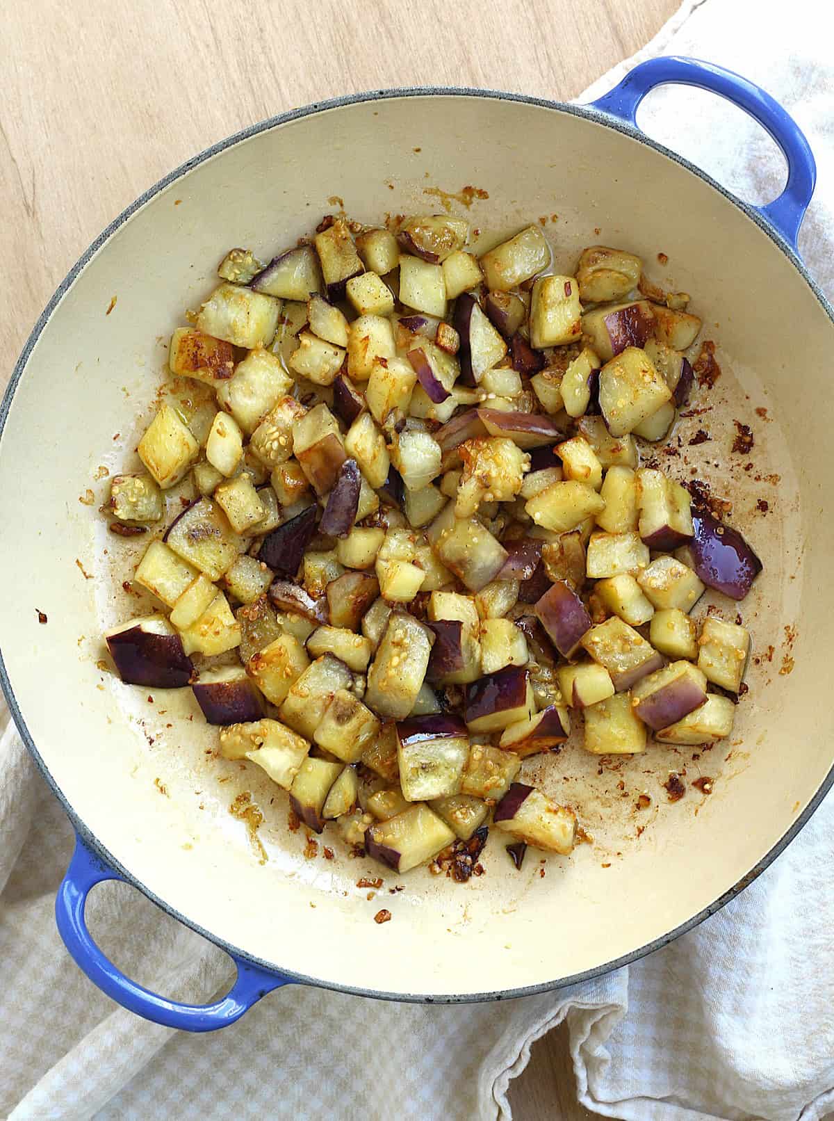 Cubed eggplant browned in skillet with olive oil.