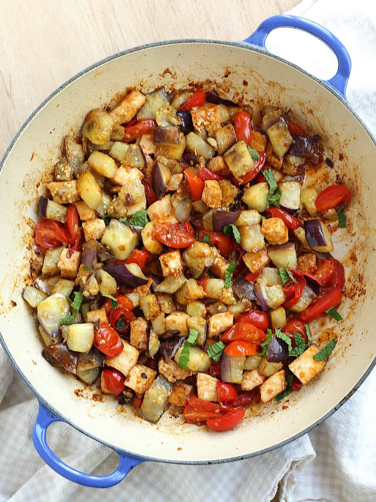 Swordfish, eggplant, and cherry tomatoes in skillet for pasta.