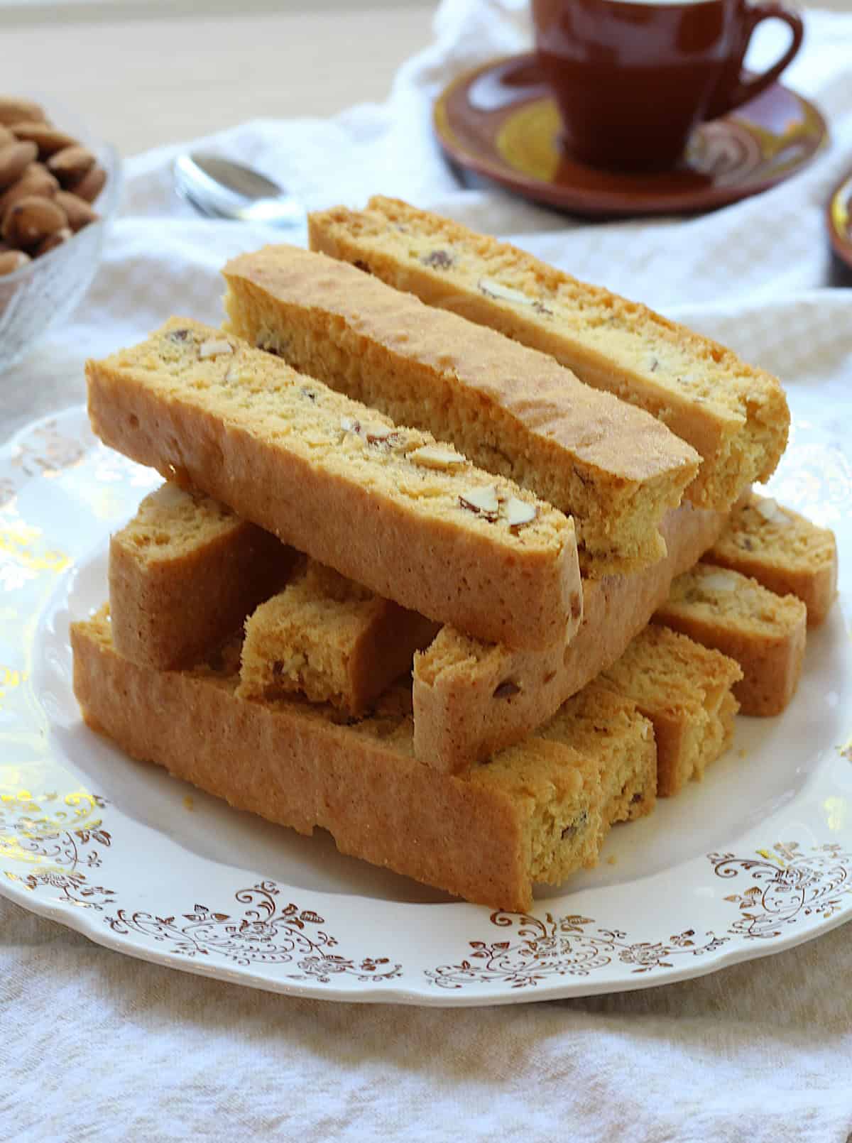 Sheet pan almond biscotti piled on serving plate.