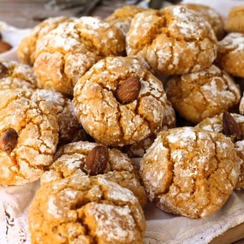 Pumpkin almond flour cookies topped with almond piled on plate.