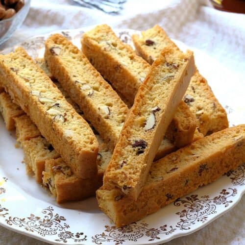 Easy sheet pan almond biscotti piled on plate.