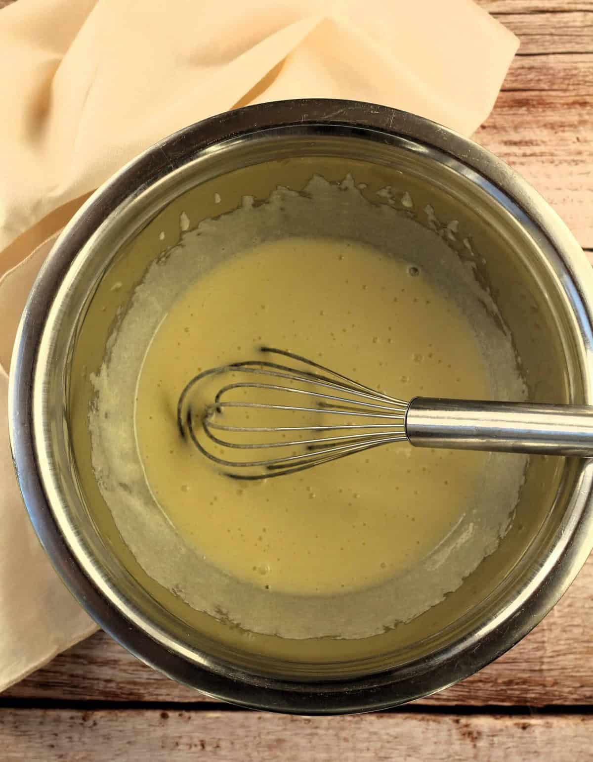 Egg, sugar and oil whisked in mixing bowl.