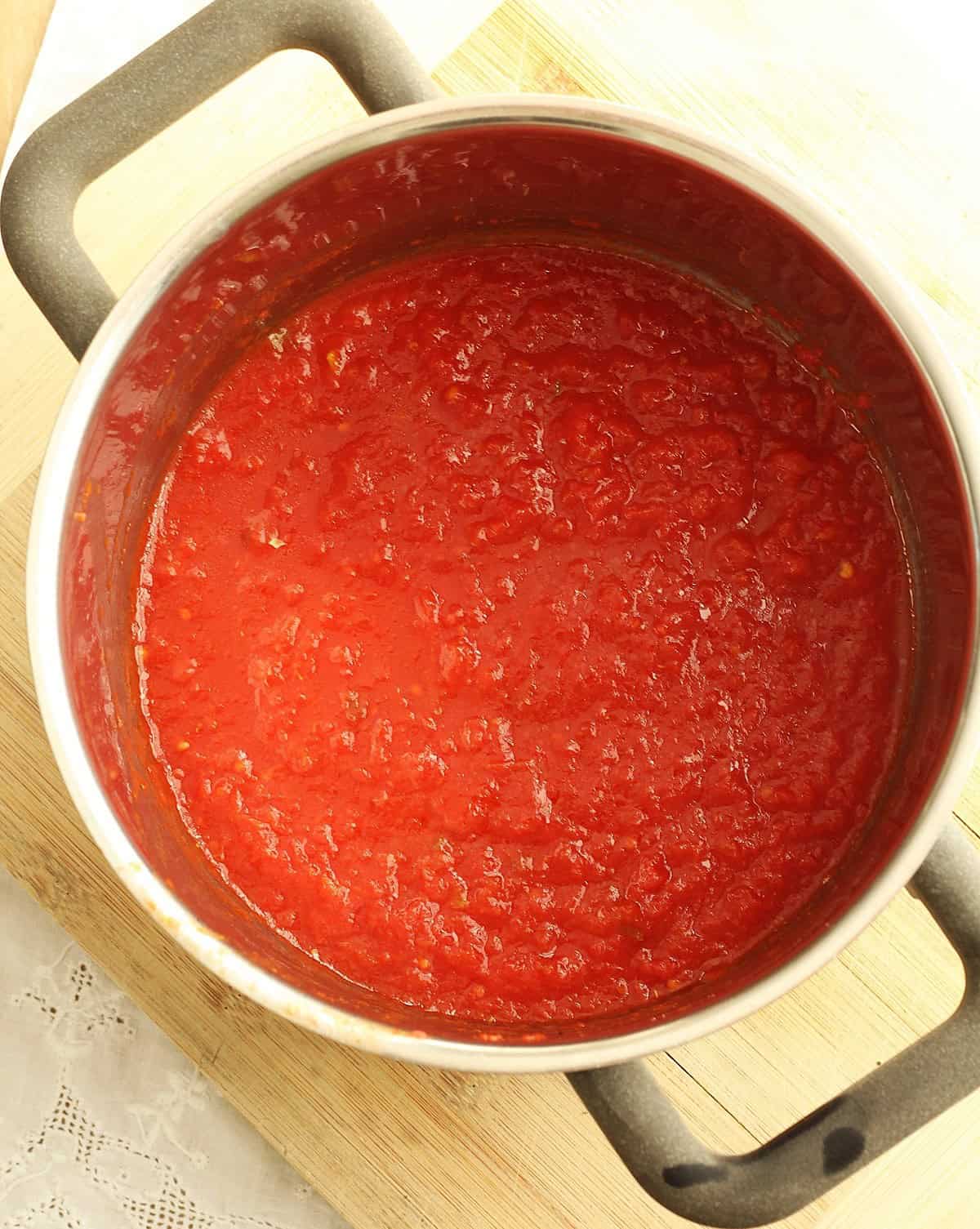 Tomato sauce in sauce pan for potatoes pizzaiola recipe.