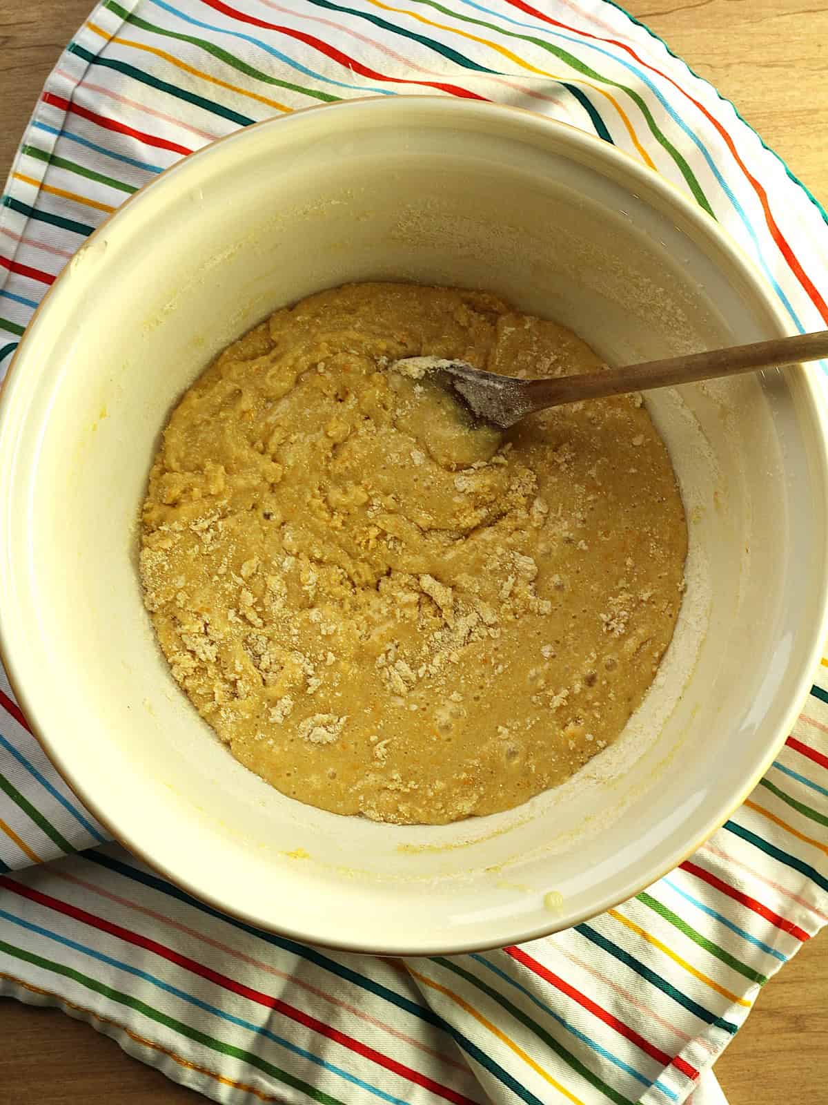 Batter for cornmeal biscotti recipe in mixing bowl with whisk.