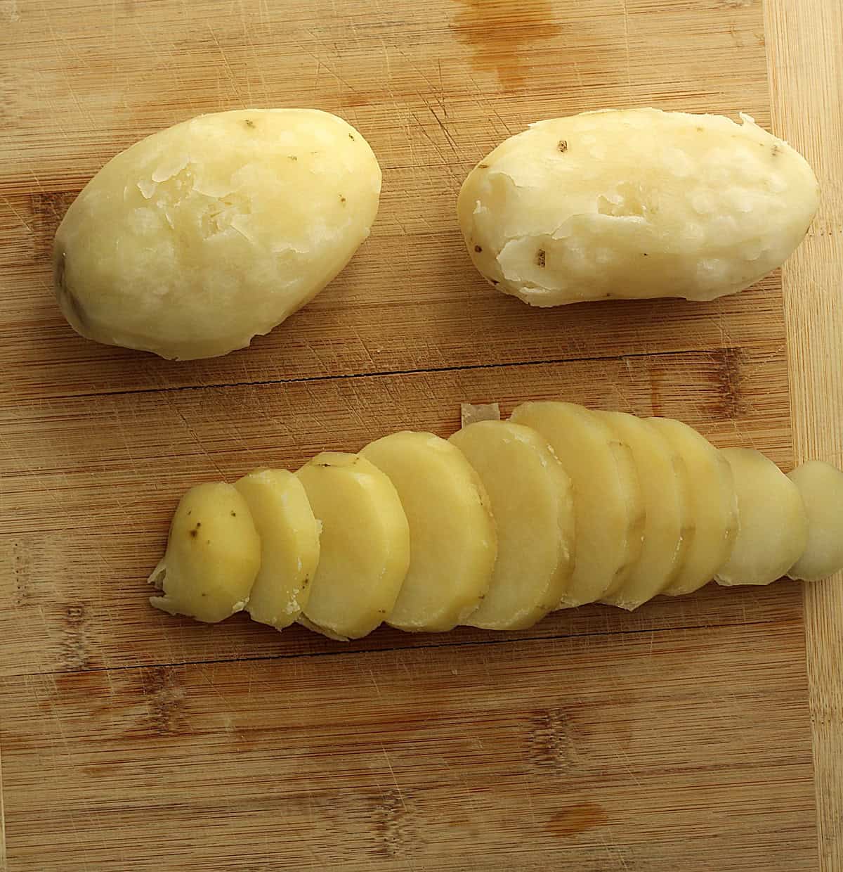 Boiled potatoes cut into slices for pizzaiola recipe.