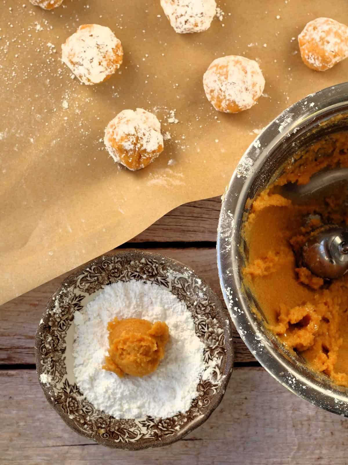 Pumpkin almond flour cookie balls rolled in powdered sugar.