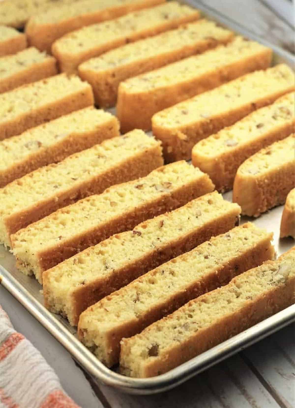 Sliced sheet pan almond biscotti sliced and placed on sheet pan.