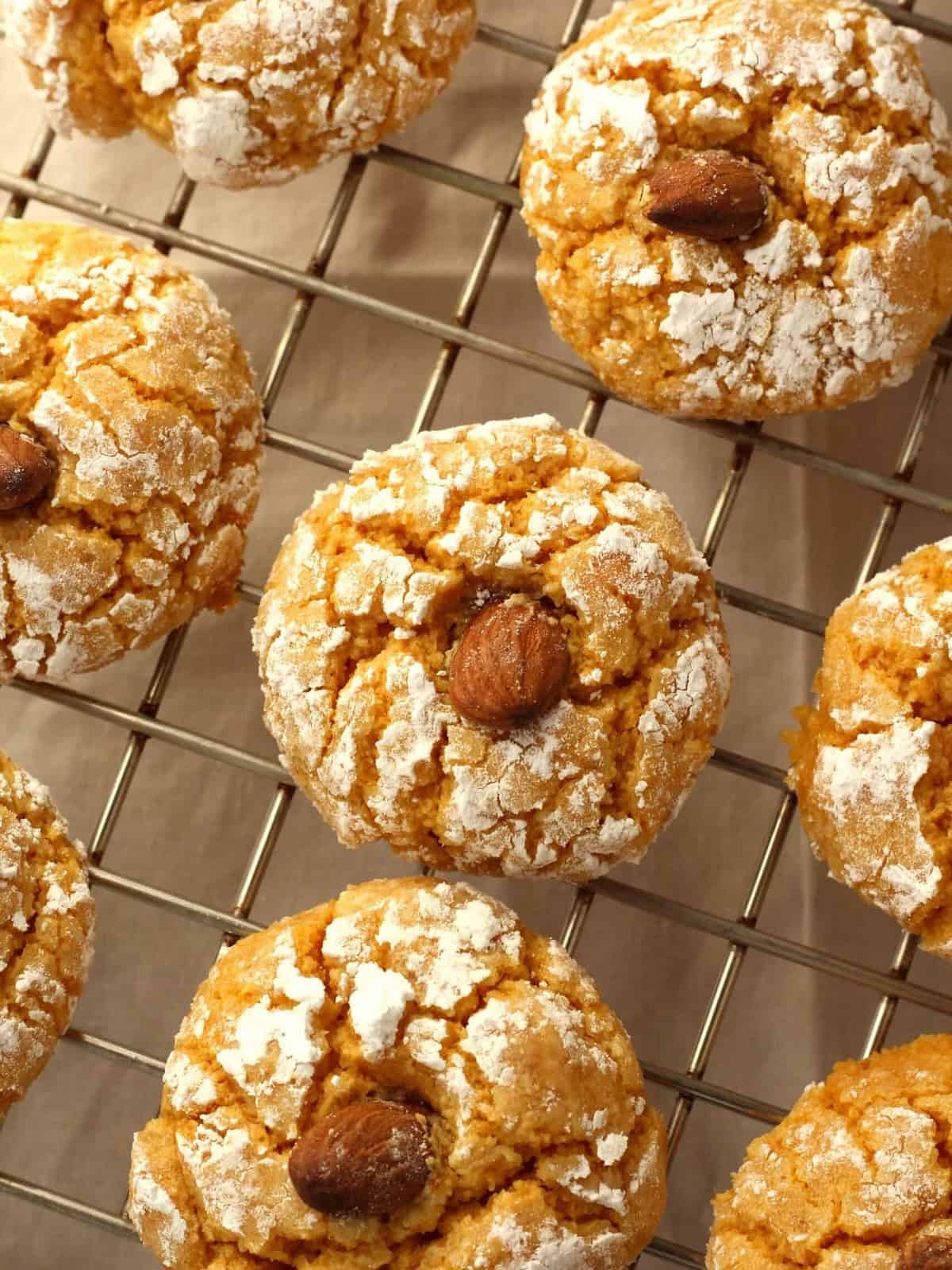 Soft pumpkin cookies with almond flour on wire rack.