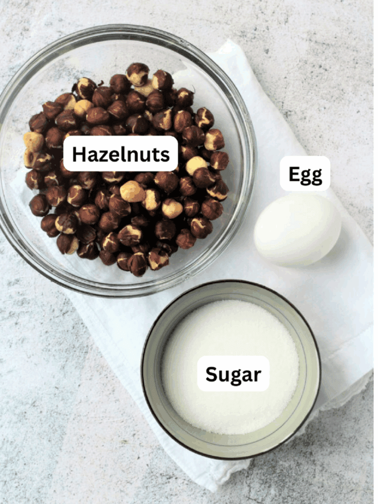 Bowl of hazelnuts, sugar and egg.