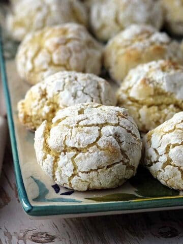Soft and chewy lemon almond cookies on serving plate.