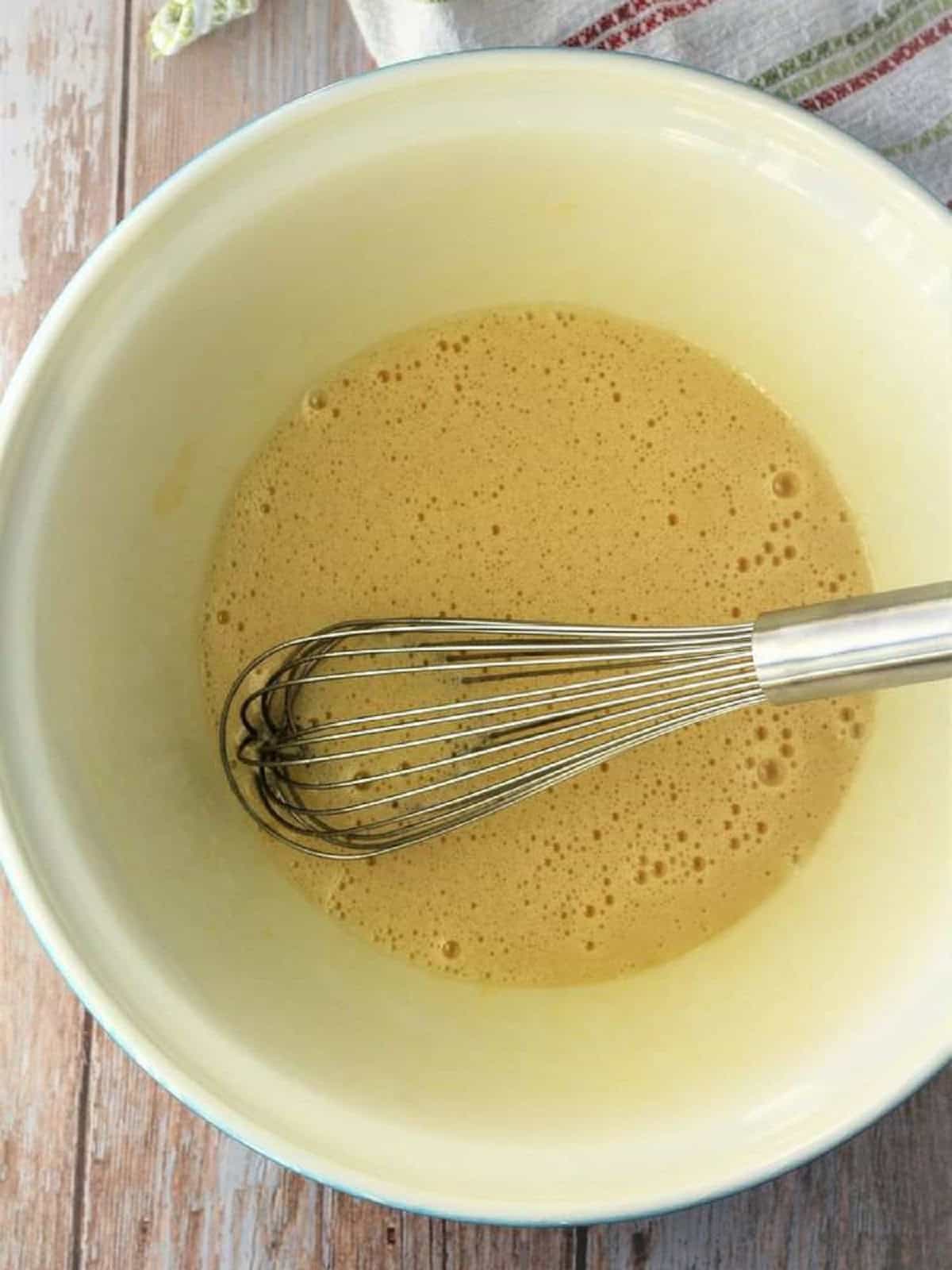 Eggs, sugar, oil and vanilla whisked together in mixing bowl.