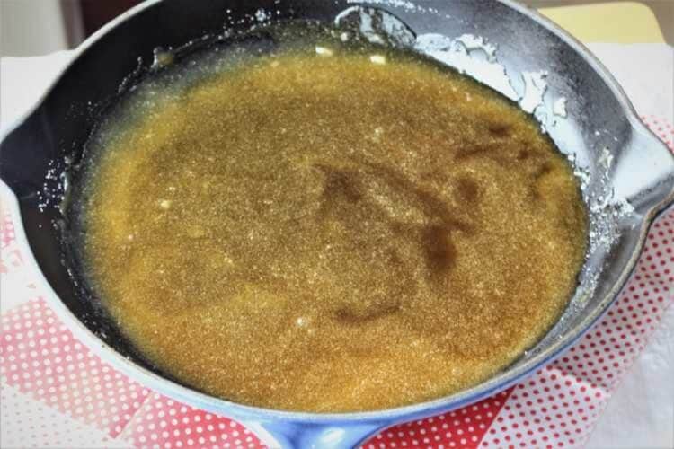 Caramaleized sugar in large skillet for making almond torrone.