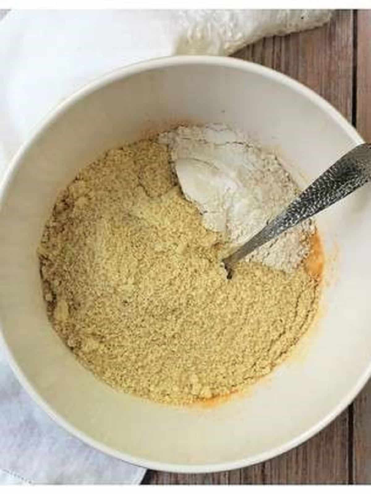 Almond flour added to bowl with egg, sugar and almond extract.