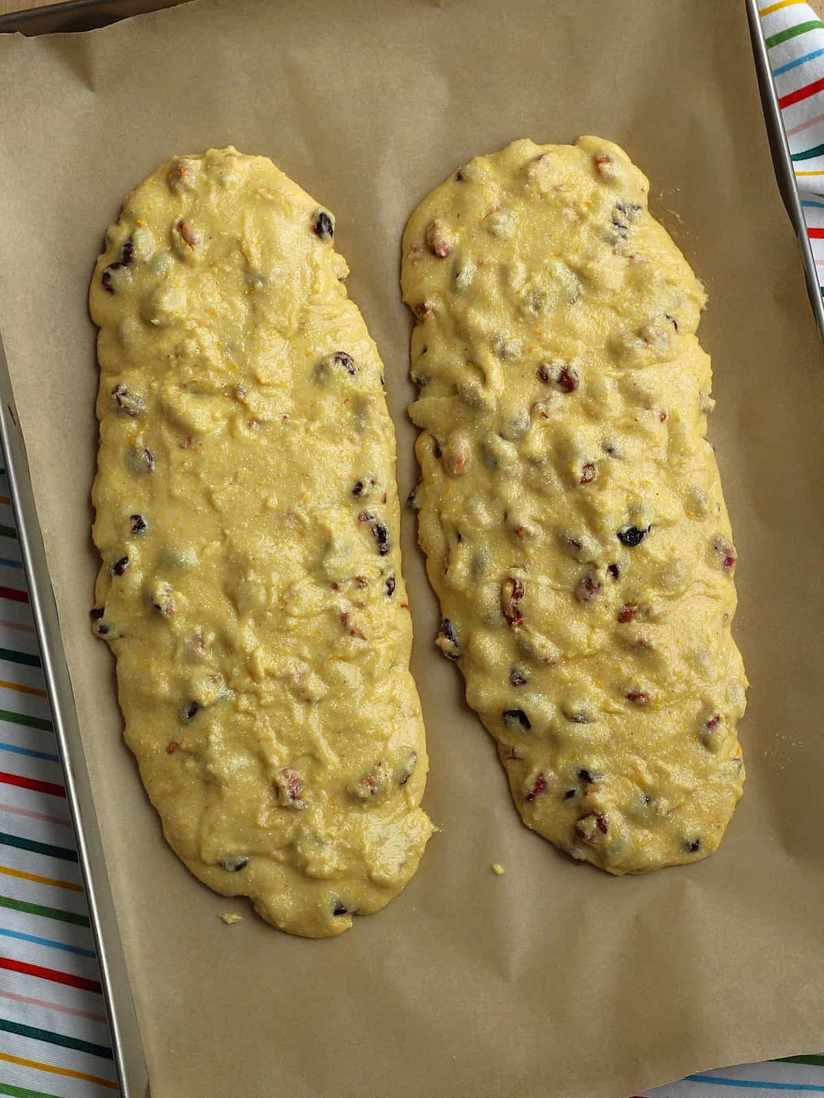 Pistachio cranberry biscotti cookie log dough on baking sheet.