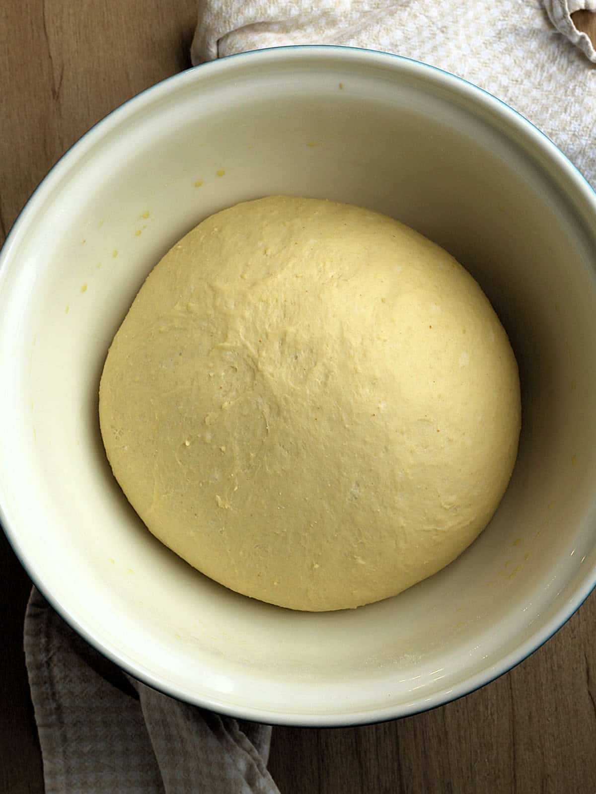 Proofed Mafalda bread dough in large bowl.