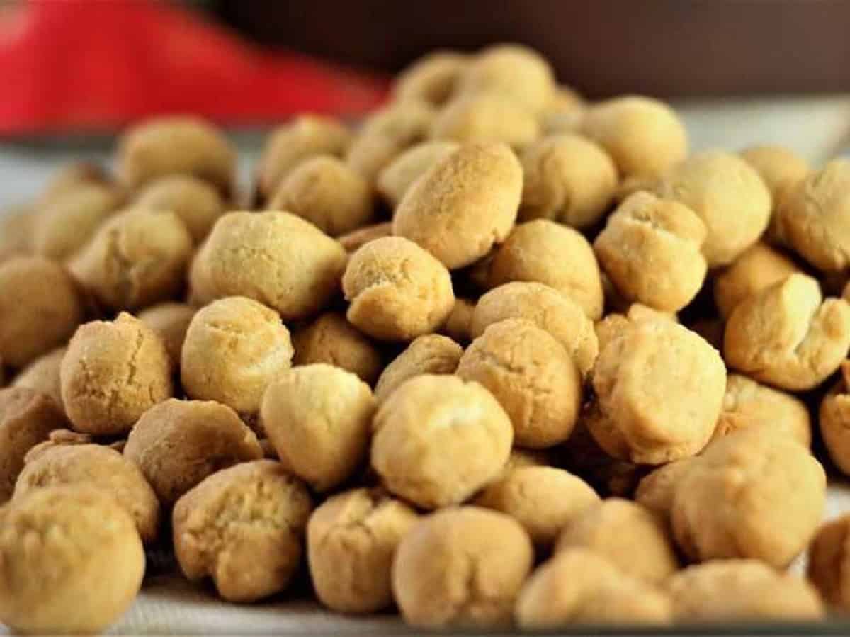 Fried pignolata pieces piled on plate.