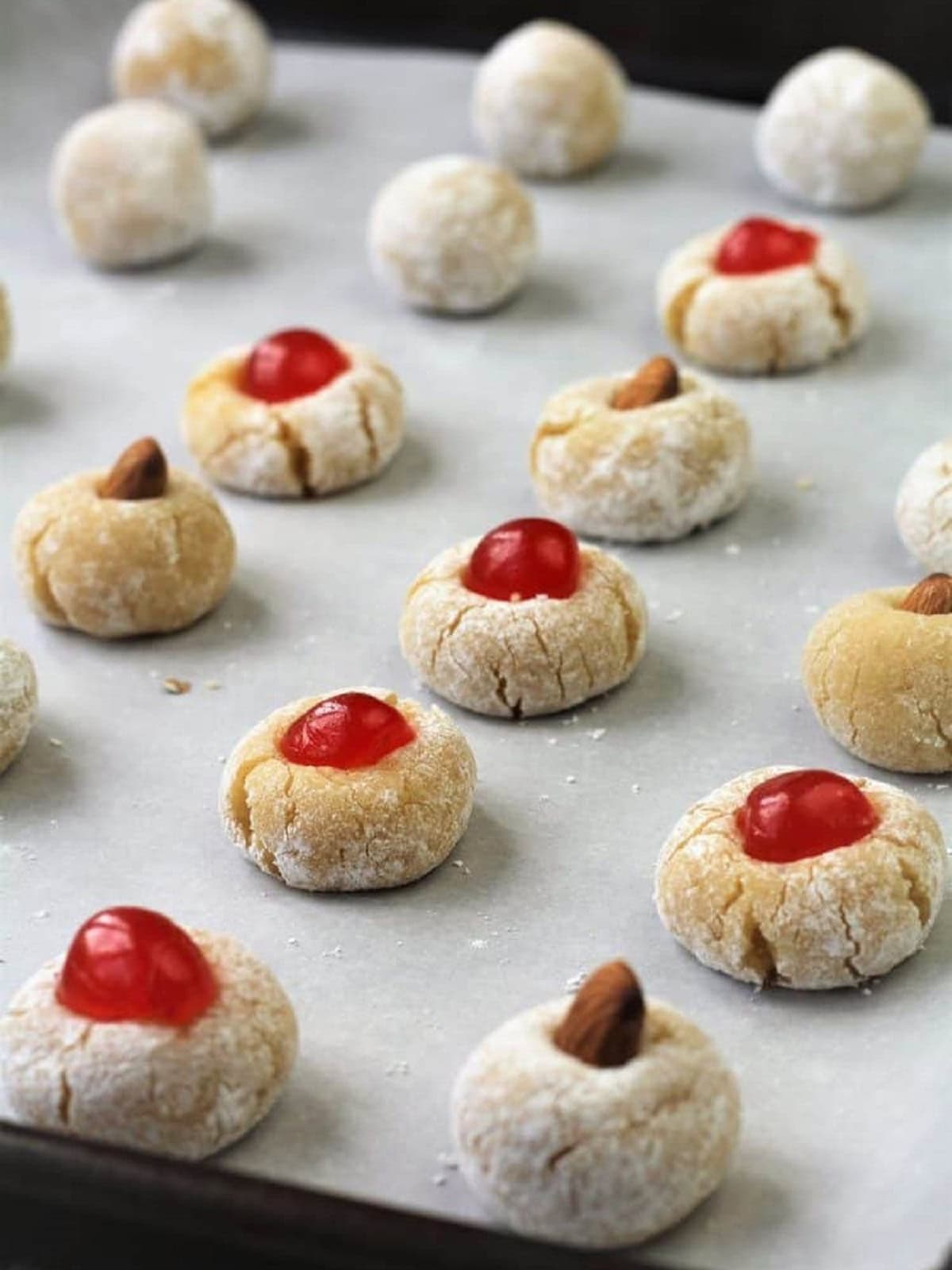 Amaretti cookie dough balls on baking sheet.
