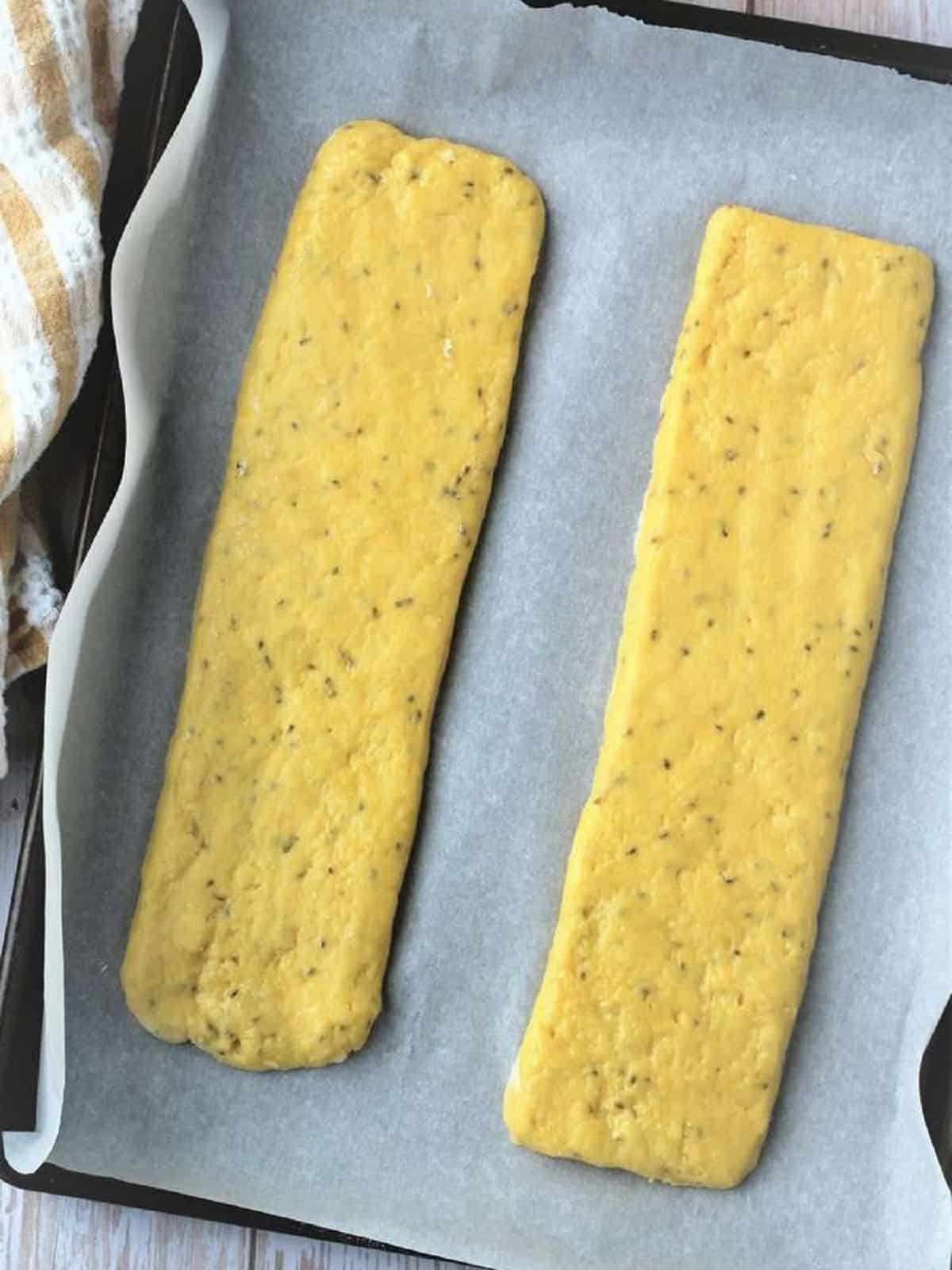 Anise biscotti dough logs on baking sheet.
