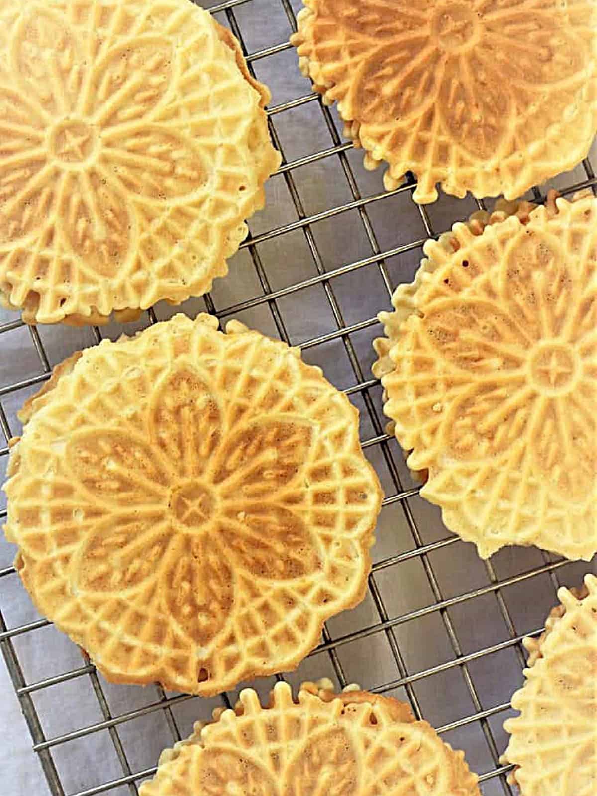 Pizzelle cookies on wire rack to cool.