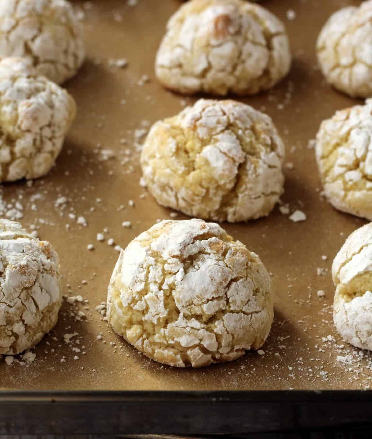 Baked lemon cookies with almond flour on baking sheet.