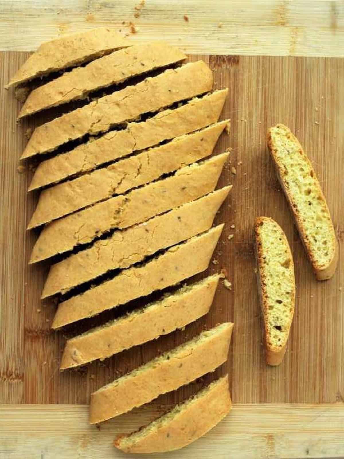 Sliced anise biscotti on wood board.