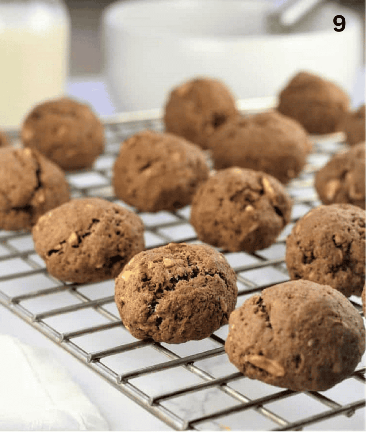 Tetù (Sicilian Chocolate Spice Cookies) Sicilian chocolate spice cookies (tetù) on wire rack.