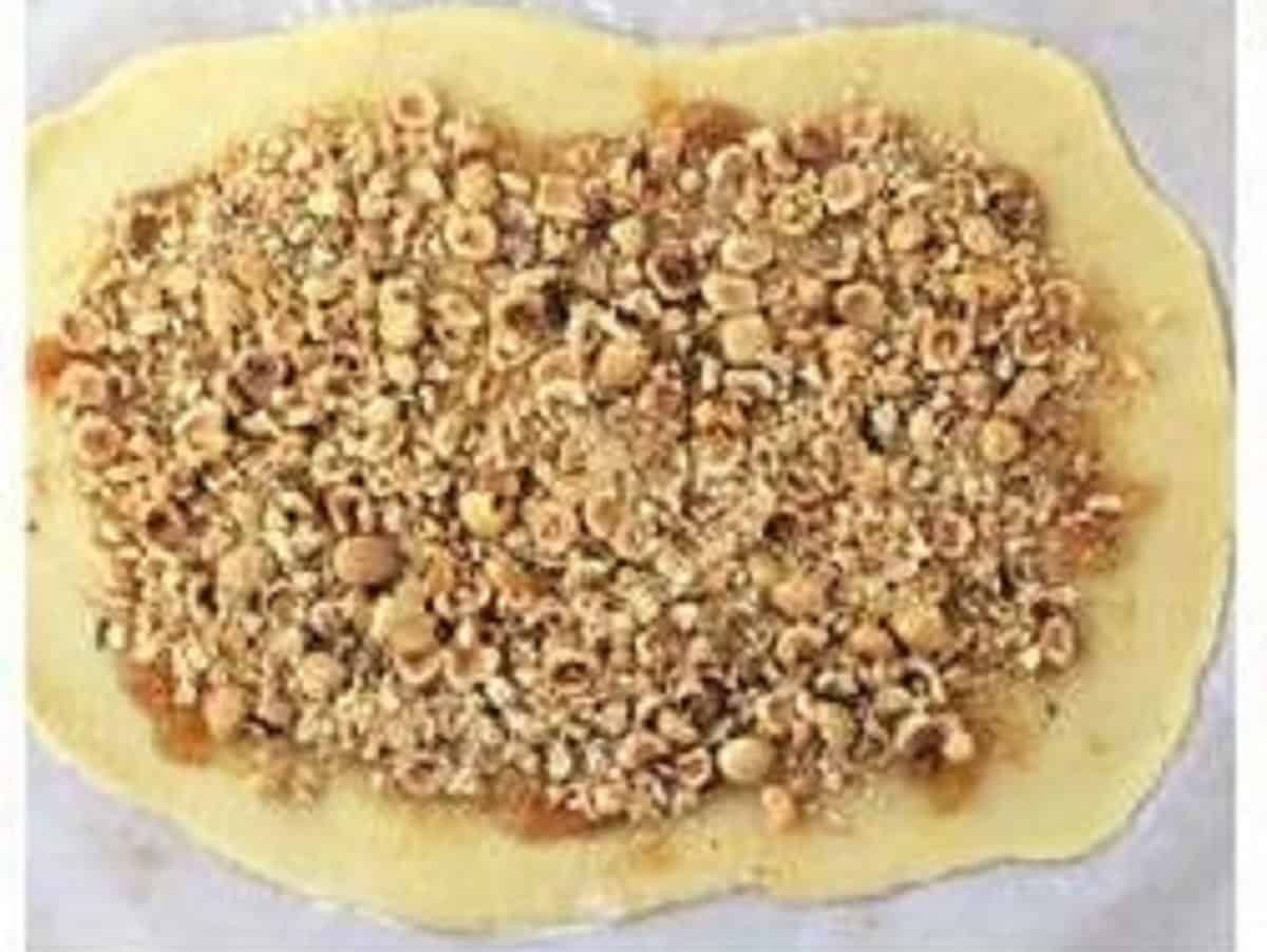 Chopped hazelnuts spread over shortcrust cookie dough.