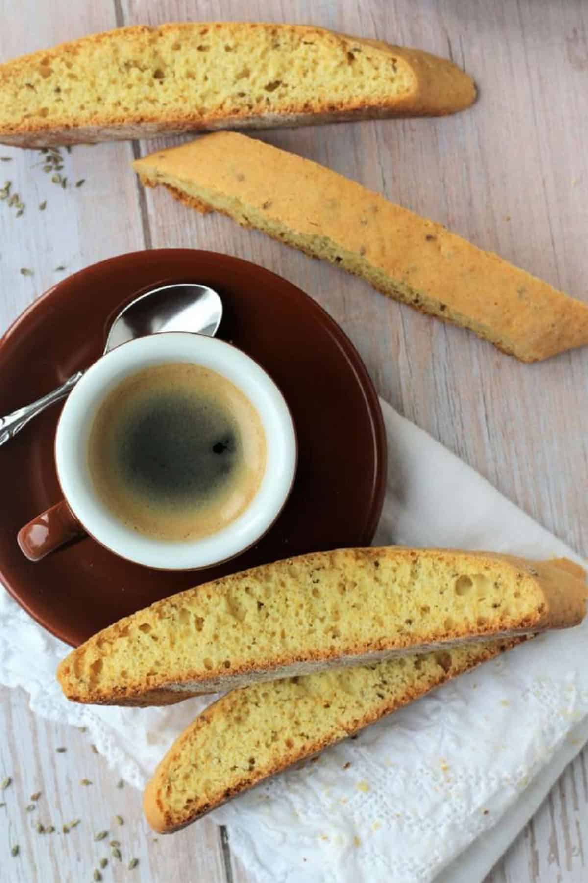 Biscotti with anise next to cup of espresso coffee.