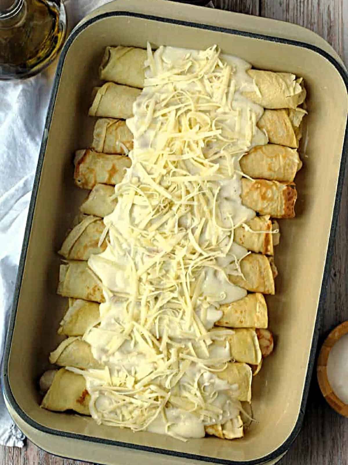 Seafood crepes topped with bechamel sauce and Gruyère cheese.