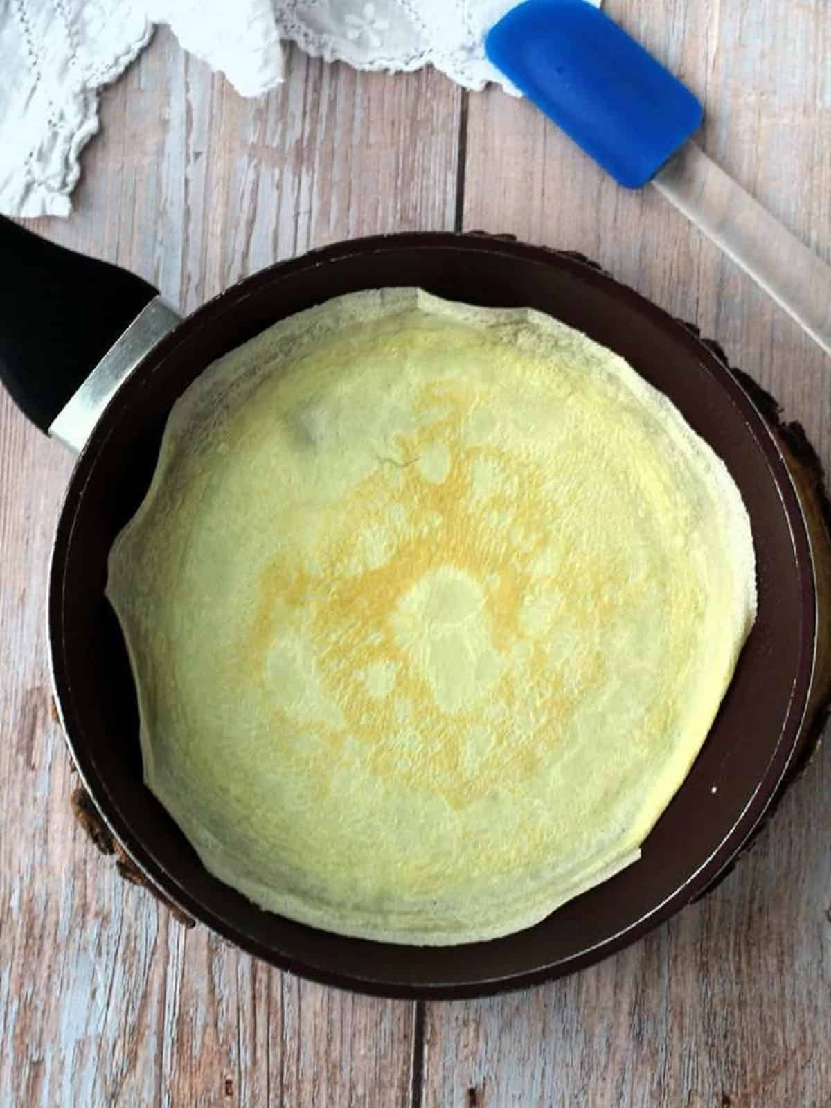 Crepe cooked in crepe pan.