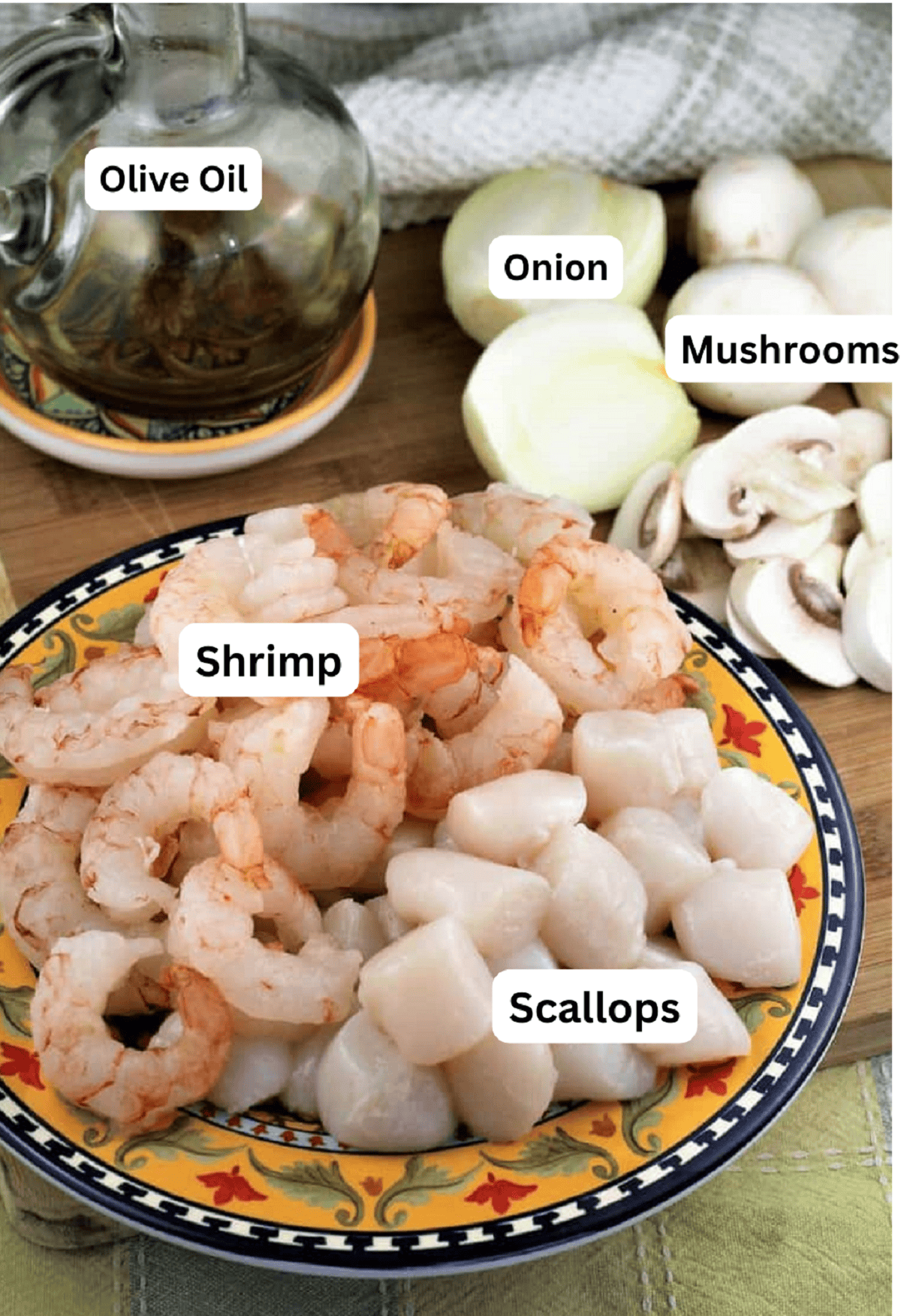 Shrimp, scallops, mushrooms, onion and olive oil for coquilles St-Jacques recipe.