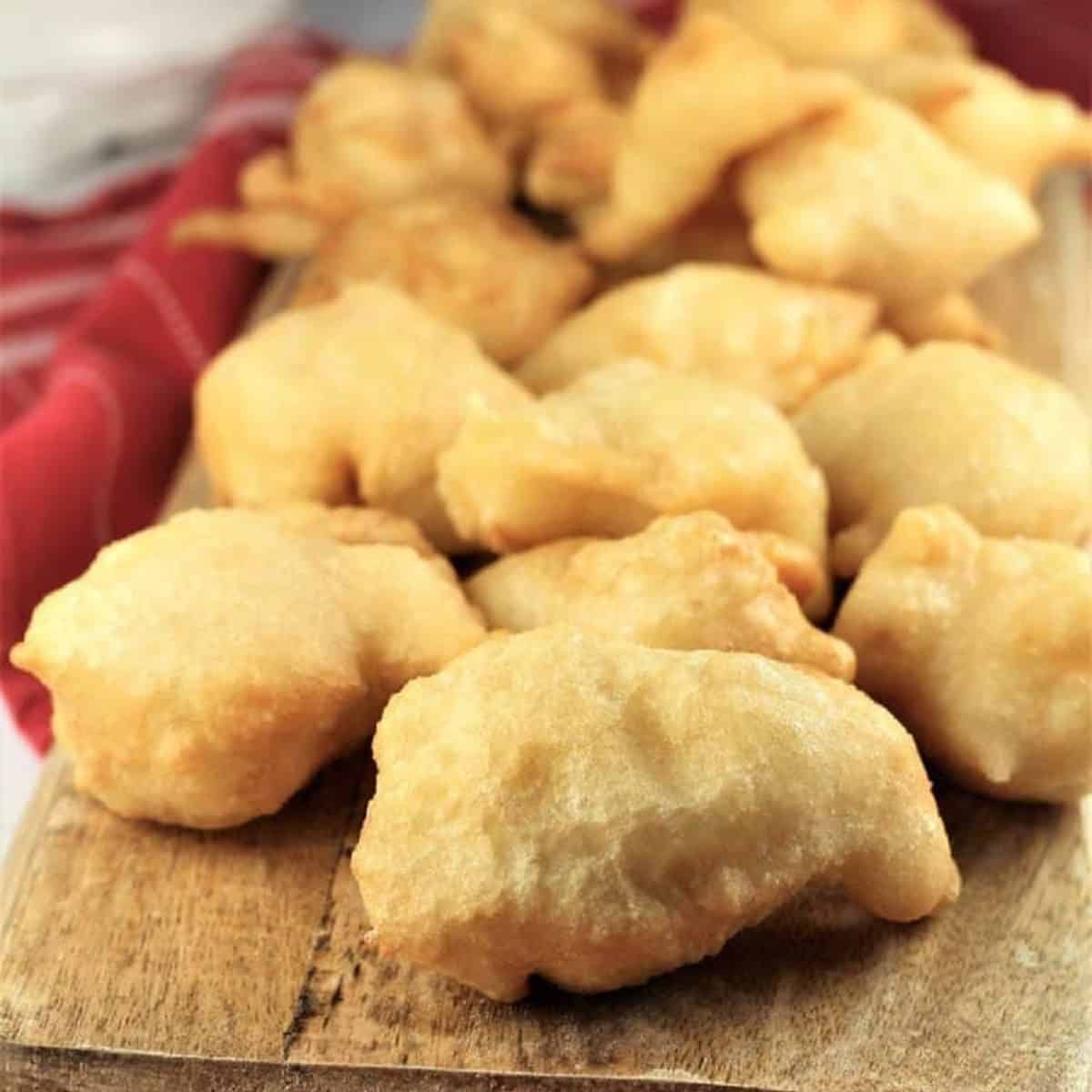 Fried Sicilian sfingi on wood boad.