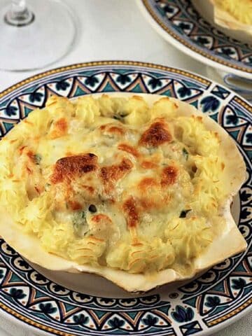 Coquilles St-Jacques, scallop shells filled with seafood in bechamel sauce.